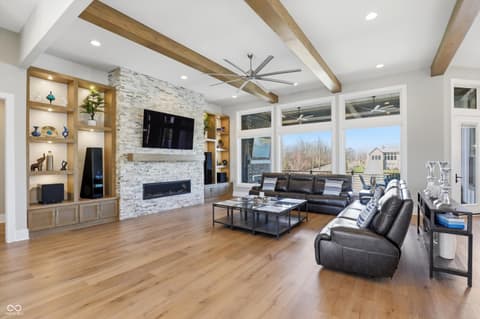 Family room at 17112 Sanders Farm Circle, Westfield, IN — Bright modern family room with fireplace and built-ins.
