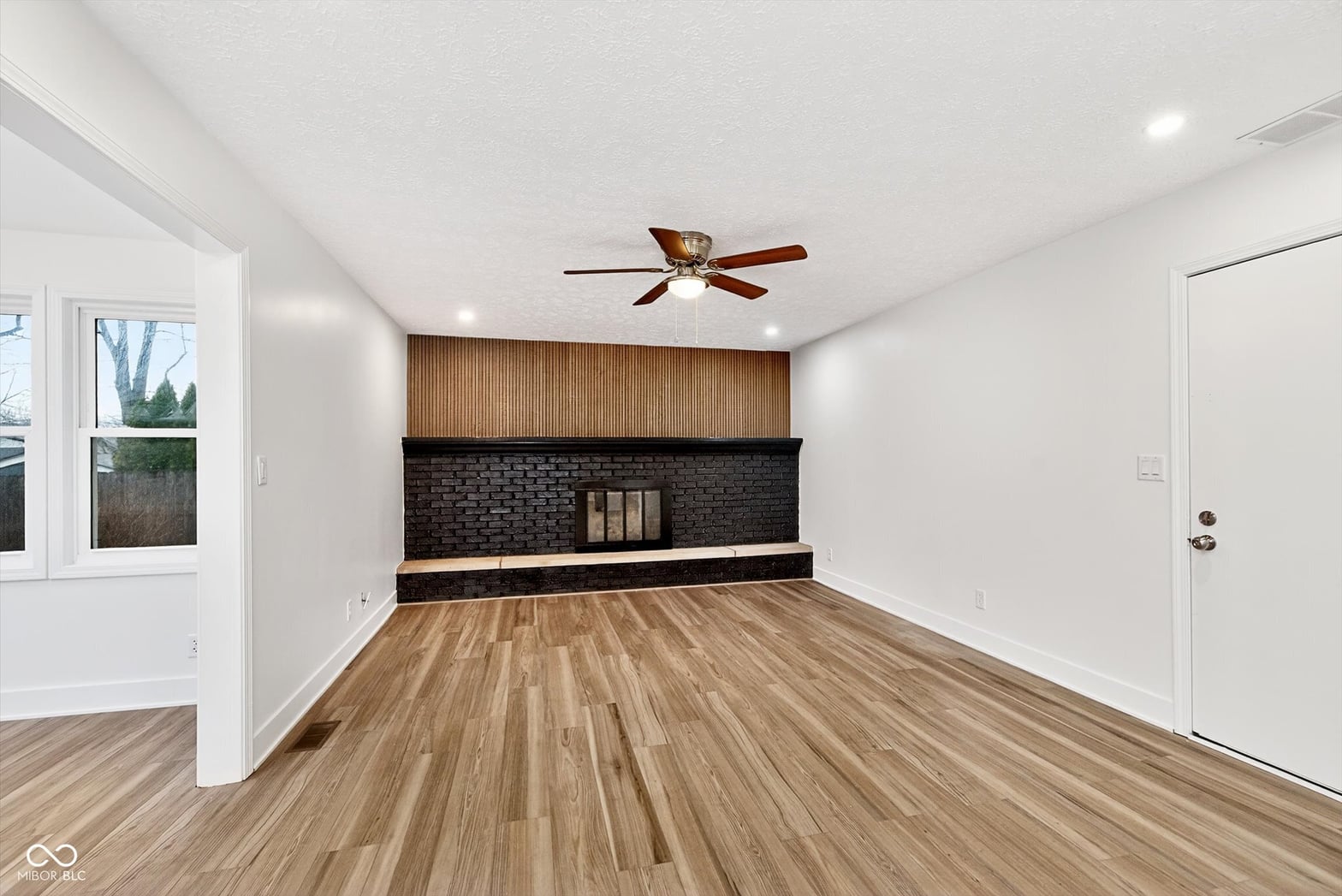 Modern family room with striking fireplace and wood accents.