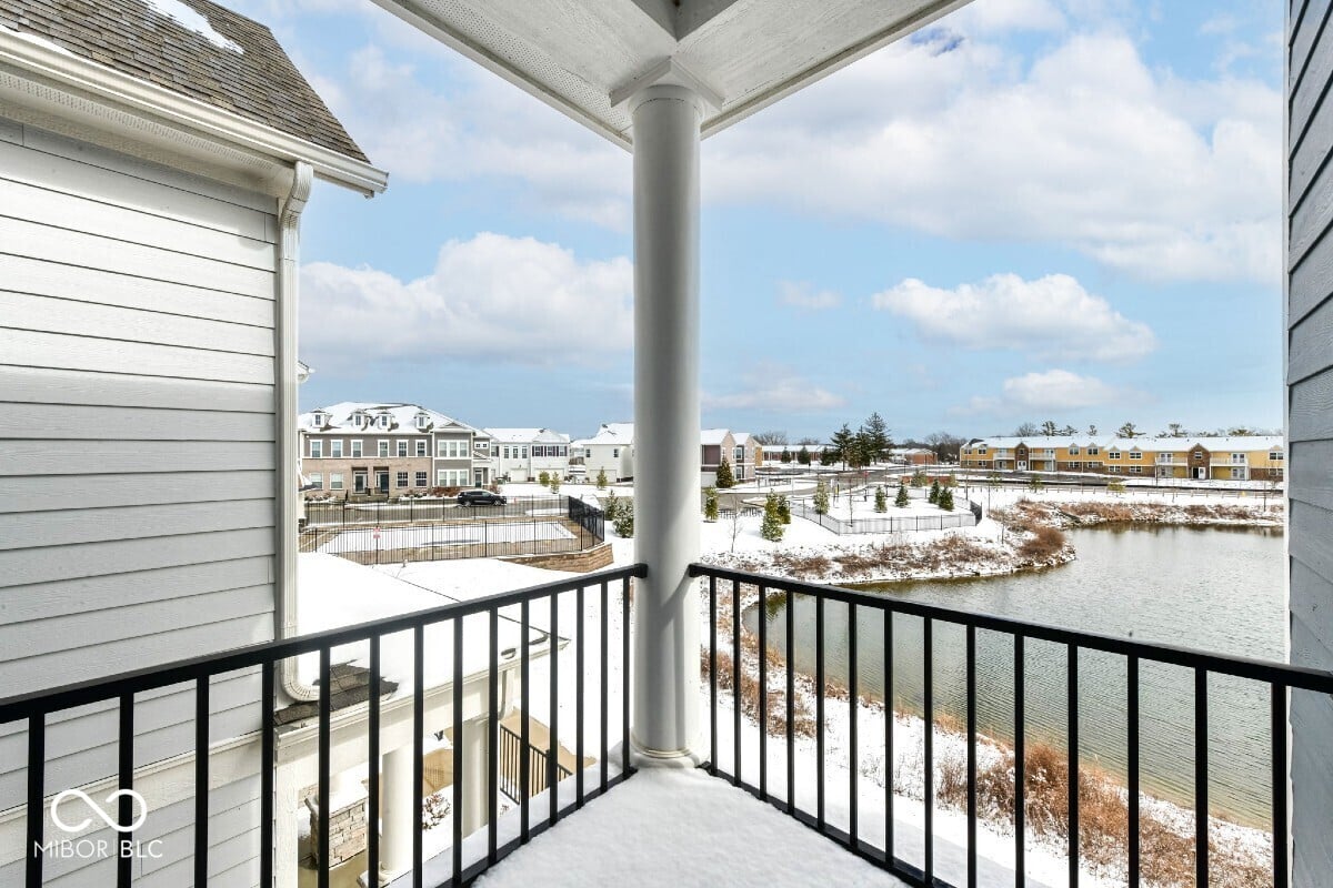 Waterfront balcony with expansive pond and neighborhood views.