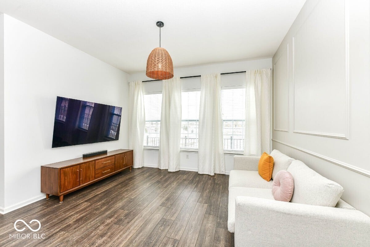 Bright modern living room with hardwood floors and natural light.