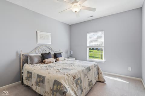 Bedroom at 9704 Brook Wood Drive, McCordsville, IN — Bright bedroom with large windows and neutral palette.