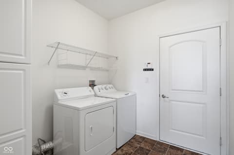 Laundry room at 9704 Brook Wood Drive, McCordsville, IN — Bright, clean laundry room with modern appliances.