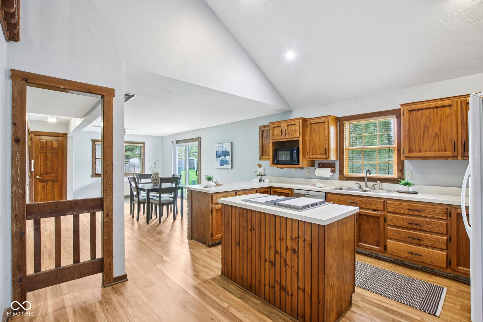 Bright open kitchen with wood cabinetry and island.