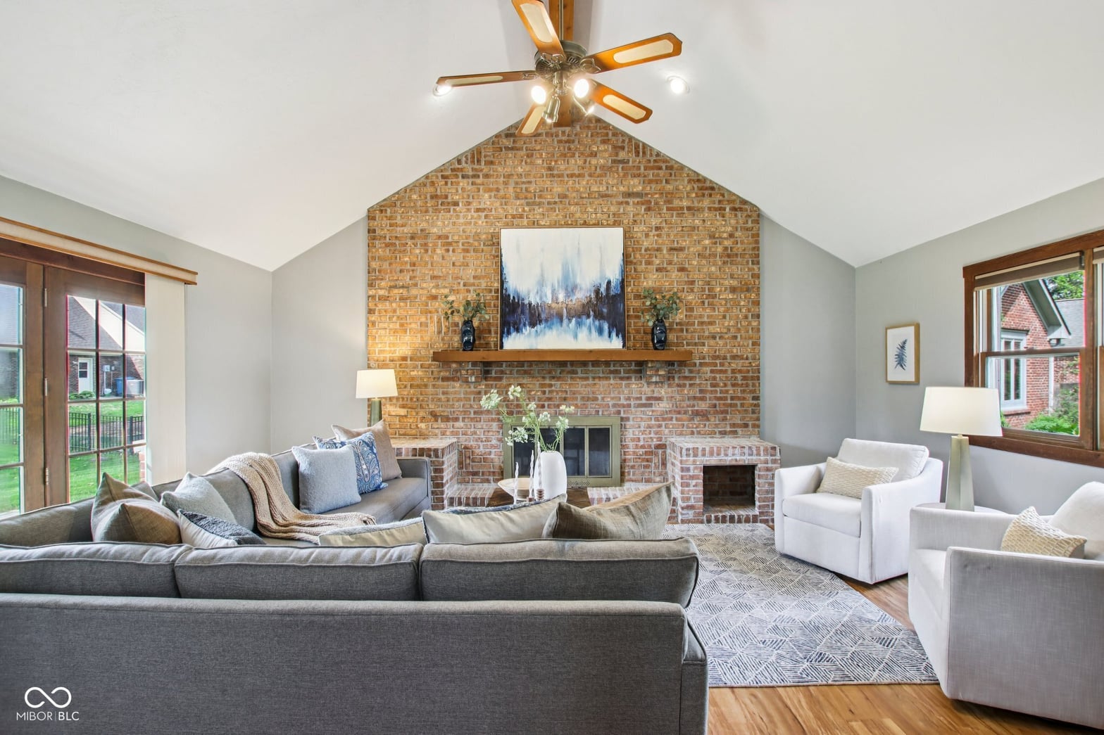 Spacious living room with stunning brick fireplace and vaulted ceilings.