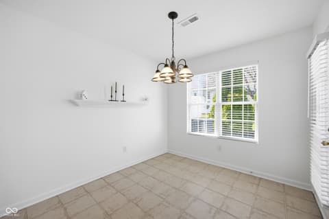 Dining room at 12706 Brewton Street, Fishers, IN — Bright dining area with large windows and modern lighting.