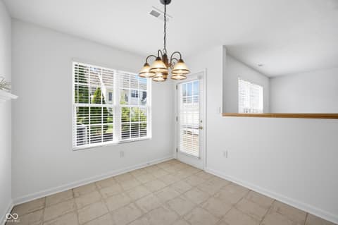 Dining room at 12706 Brewton Street, Fishers, IN — Bright dining room with abundant natural light and shutters.