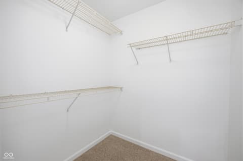 Bedroom at 12706 Brewton Street, Fishers, IN — Spacious walk-in closet with organized wire shelving.
