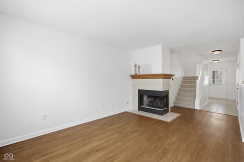Living room at 12706 Brewton Street, Fishers, IN — Spacious living room with gas fireplace and hardwood floors.