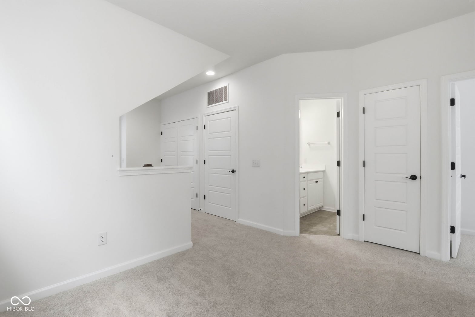 Spacious primary suite with walk-in closet and ensuite bathroom.
