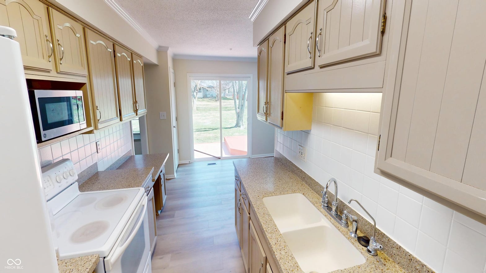 Spacious galley kitchen with granite counters and updated finishes.