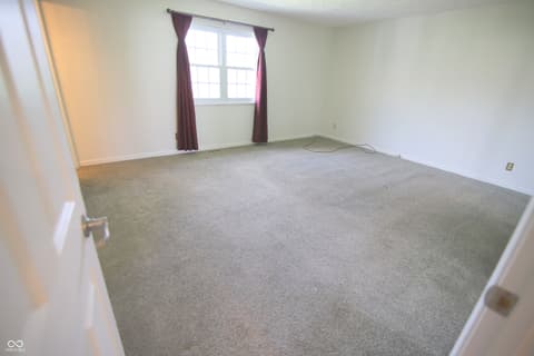 Bedroom at 104 Apple Tree Court, Fishers, IN — Spacious bedroom with abundant natural light from window.