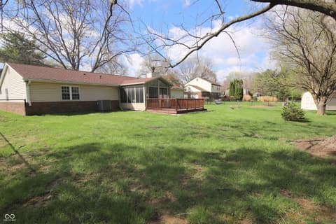 Backyard at 104 Apple Tree Court, Fishers, IN — Generous backyard with mature trees and deck.