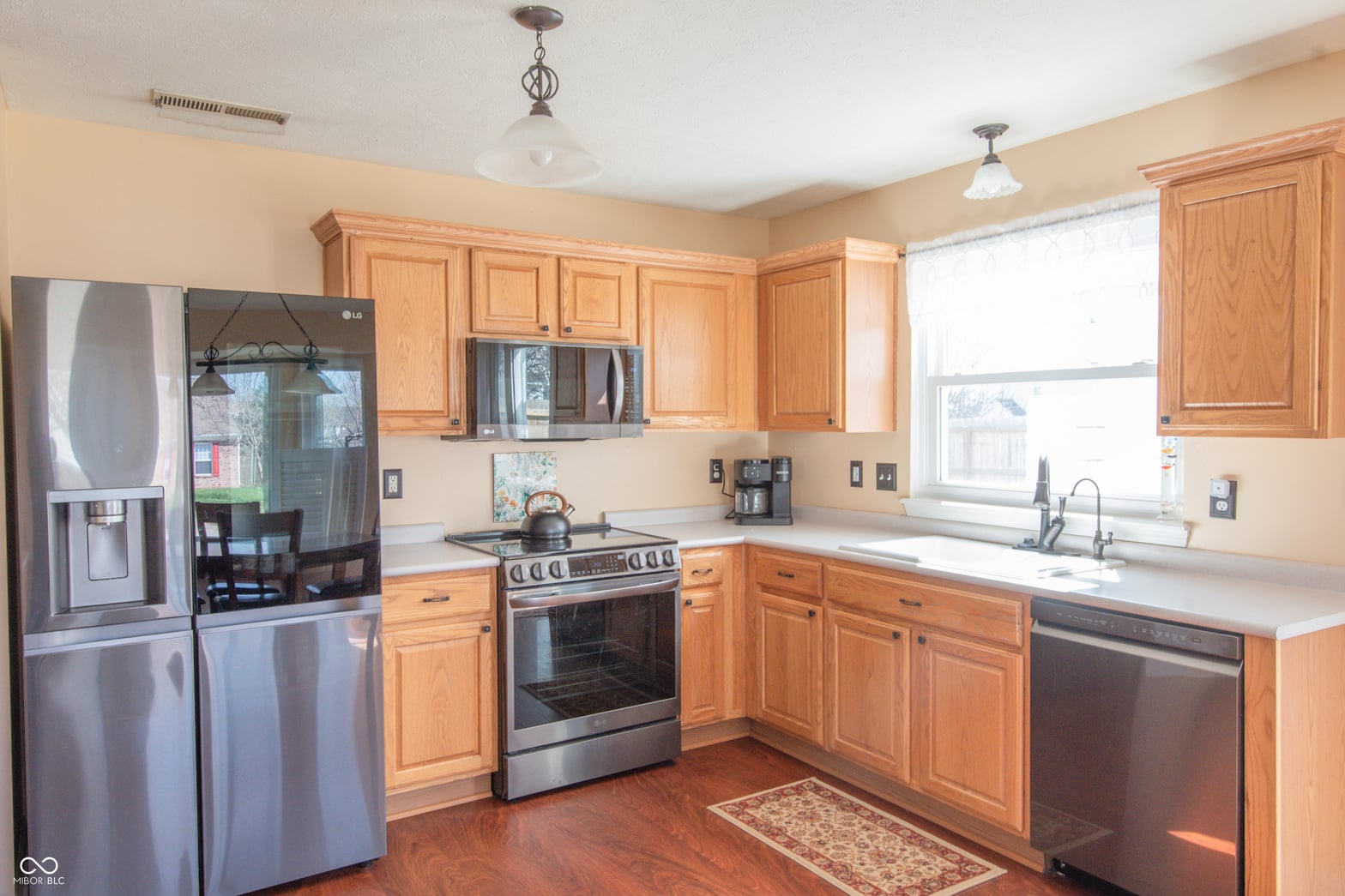 Spacious kitchen with oak cabinets and stainless steel appliances.