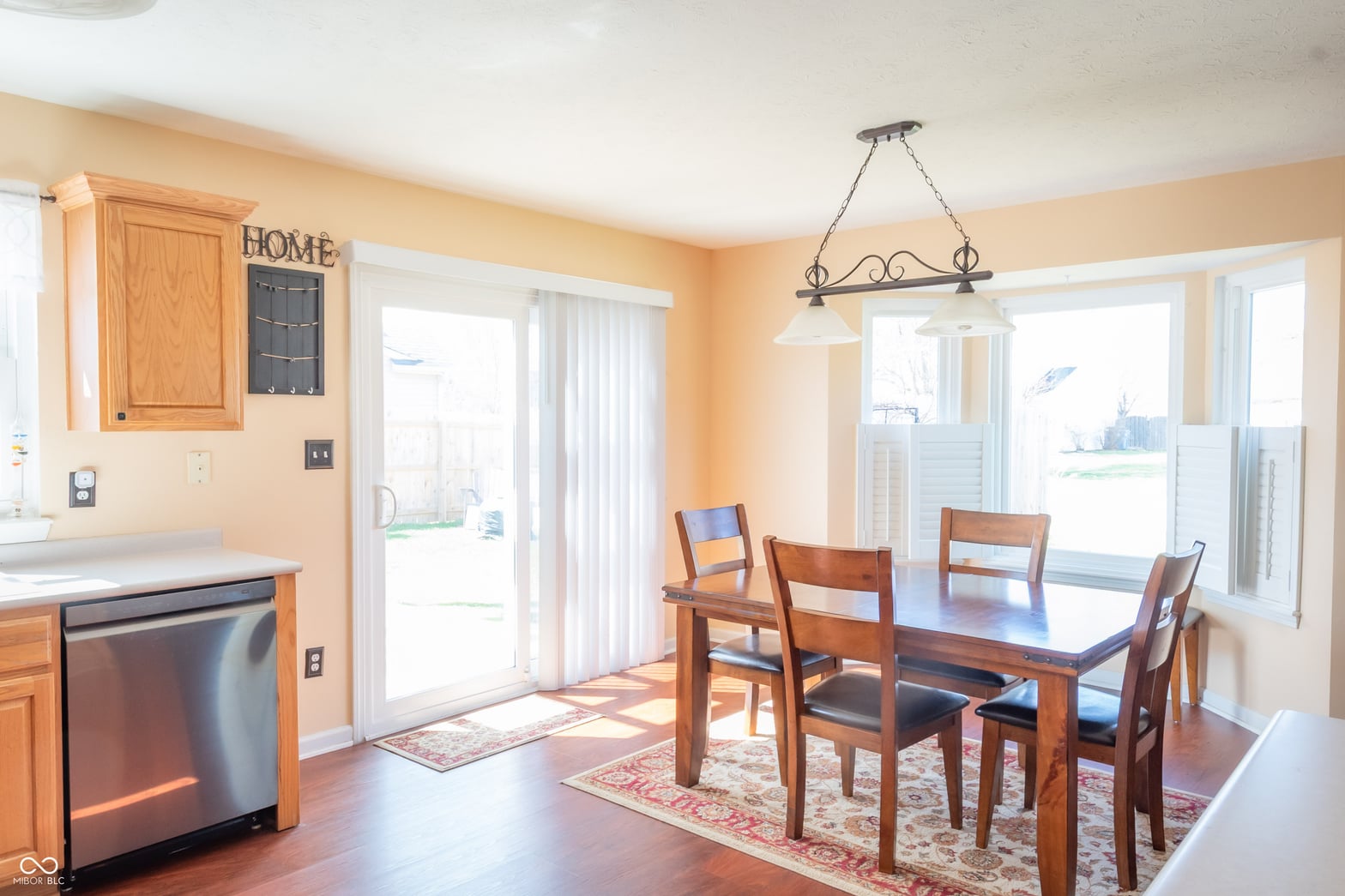 Bright dining area with hardwood floors and patio access.