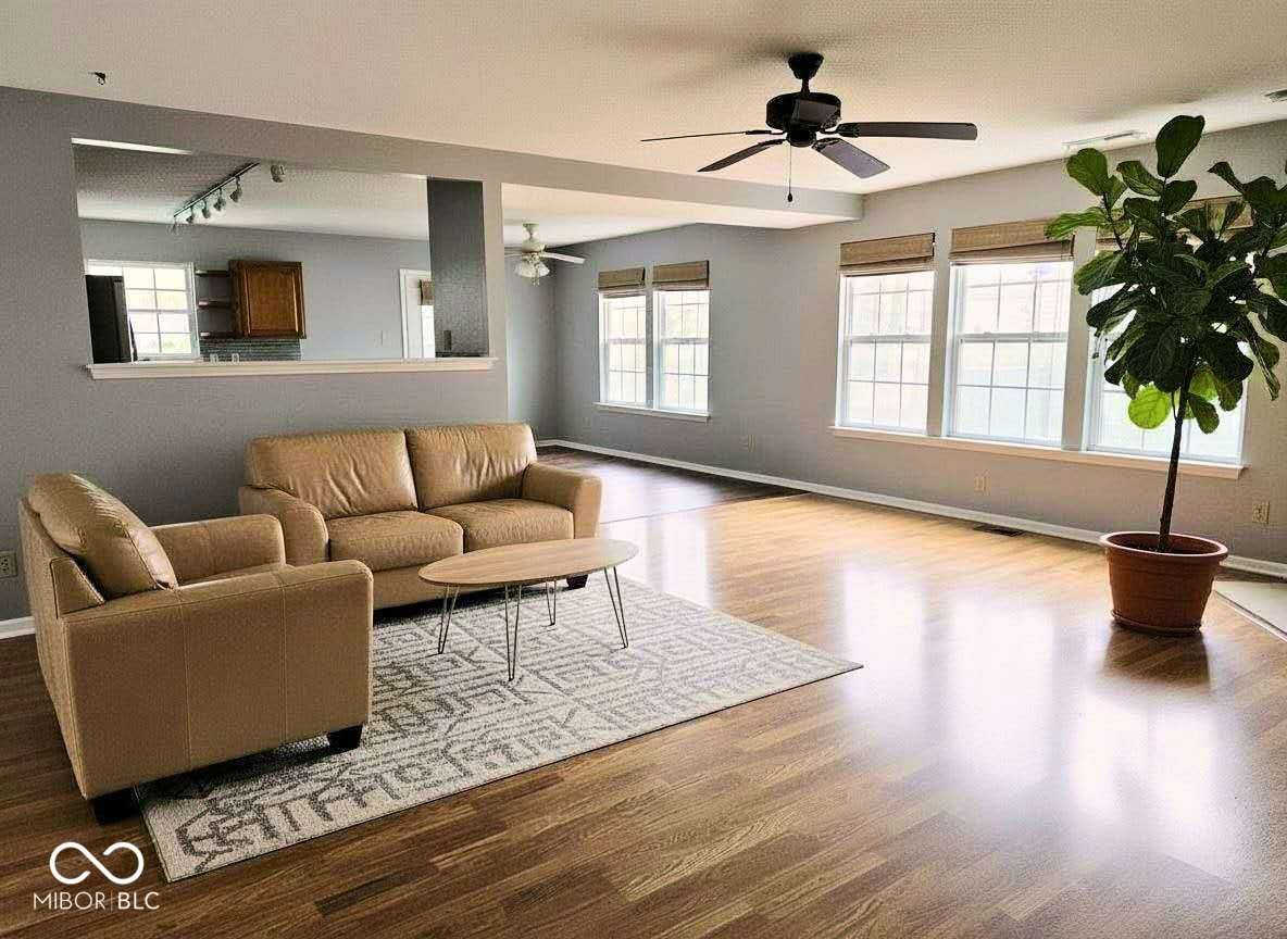 Bright open living space with gleaming hardwood floors.