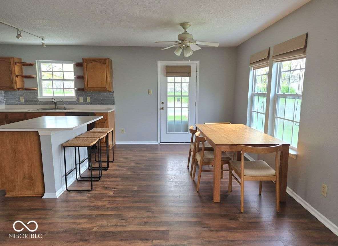 Open kitchen and dining with hardwood floors and updated finishes.