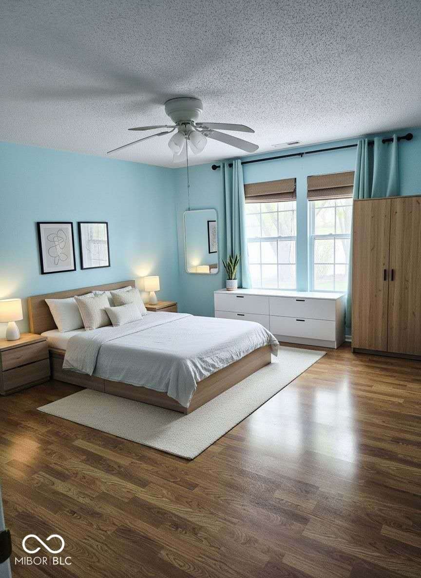 Bright, updated primary bedroom with hardwood floors.