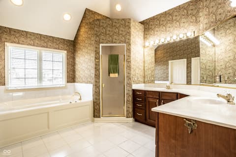 Primary bathroom at 2444 Laurel Lake Boulevard, Carmel, IN — Spacious primary bath with dual vanity and soaking tub.