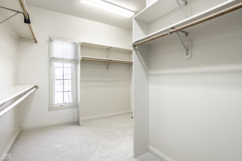 Primary bedroom at 2444 Laurel Lake Boulevard, Carmel, IN — Spacious walk-in closet with excellent storage organization.