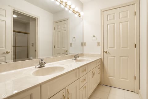 Primary bathroom at 2444 Laurel Lake Boulevard, Carmel, IN — Spacious primary bath with dual vanity and marble counters.