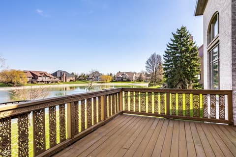 Outdoor living area at 2444 Laurel Lake Boulevard, Carmel, IN — Stunning waterfront deck with ornate railing and lake views.