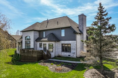 Backyard at 2444 Laurel Lake Boulevard, Carmel, IN — Well-maintained brick home with professional landscaping.