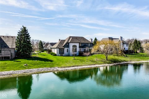 Front exterior at 2444 Laurel Lake Boulevard, Carmel, IN — Stunning waterfront estate with pristine private pond.