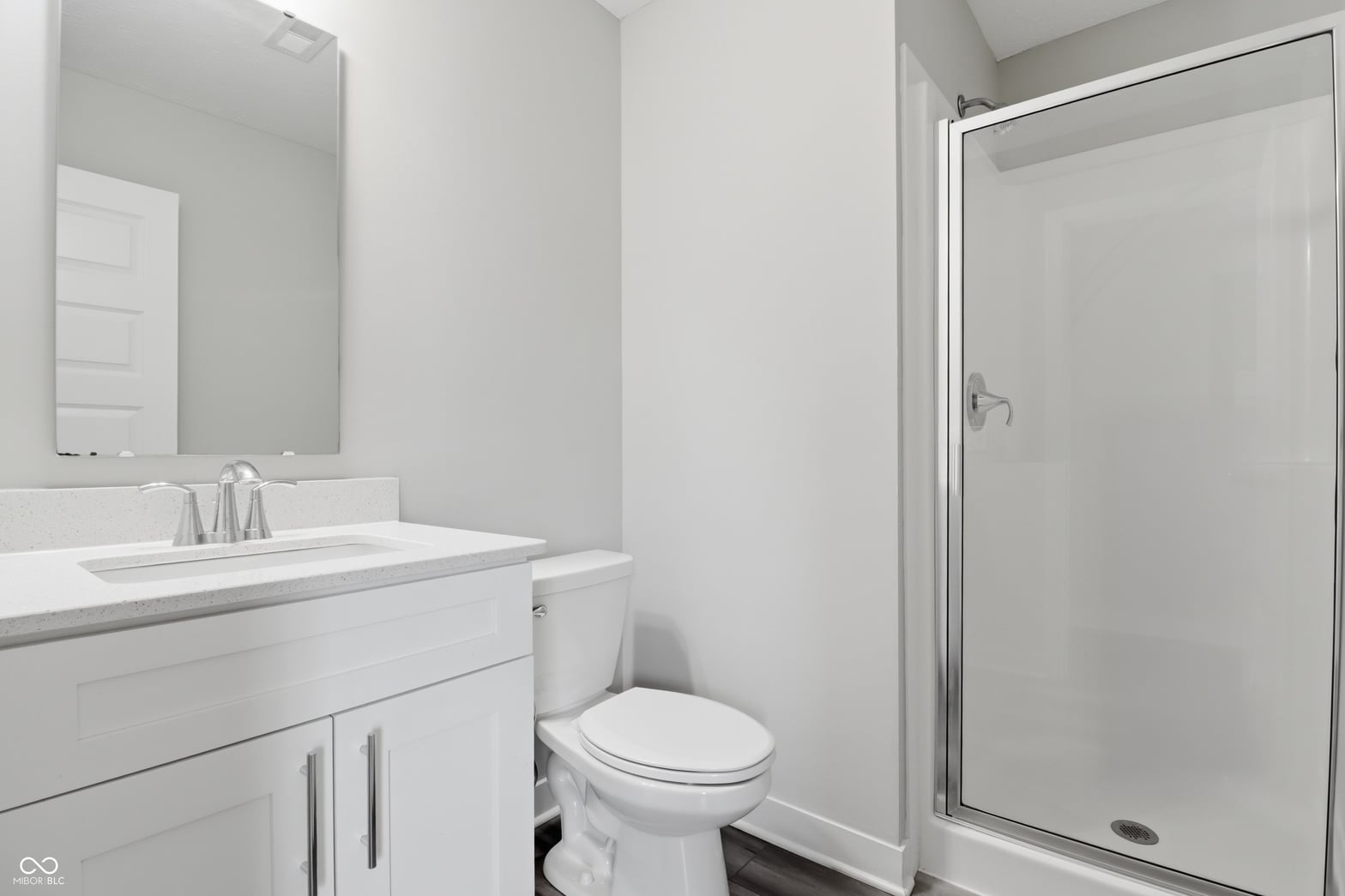 Spa-like primary bathroom with glass shower and vanity storage.