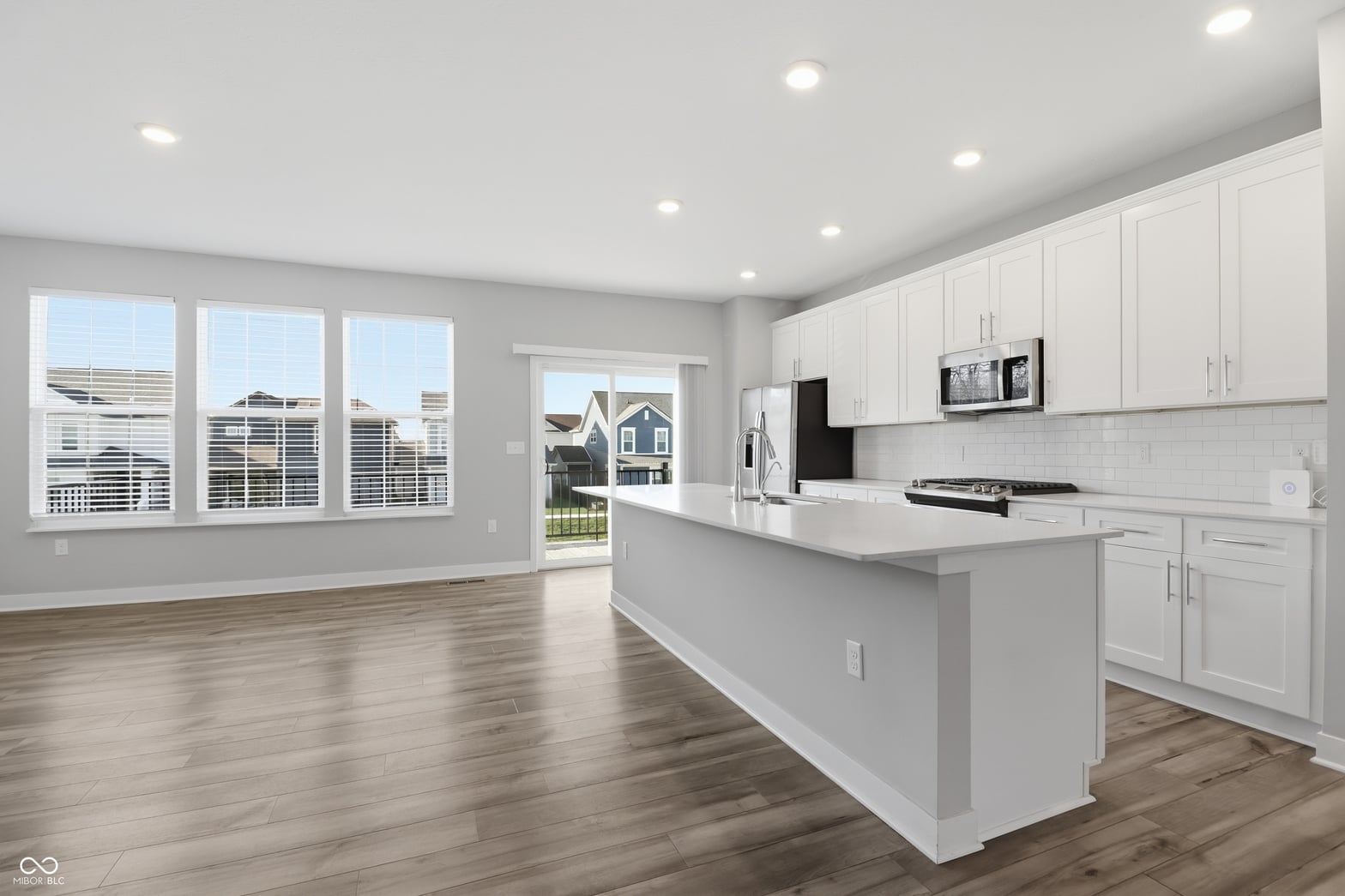 Bright modern kitchen with large island and abundant natural light.
