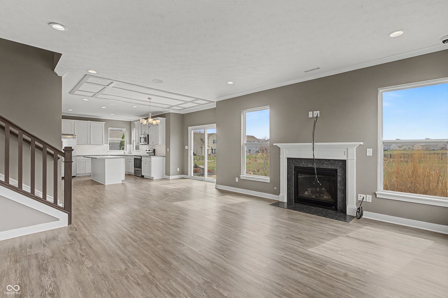 Spacious open-concept living with fireplace and panoramic views.
