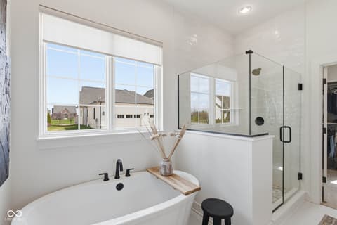 Primary bathroom at 1541 Cantata Lane, Westfield, IN — Luxurious primary bath with soaking tub and spa shower.
