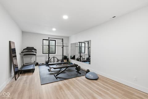 Bonus room at 1541 Cantata Lane, Westfield, IN — Dedicated home gym with mirrors and professional equipment.