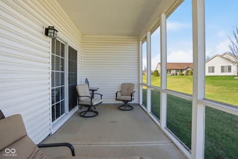 Outdoor living area at 6906 Harbour Woods Overlook, Noblesville, IN — Spacious screened porch with views of manicured lawn.