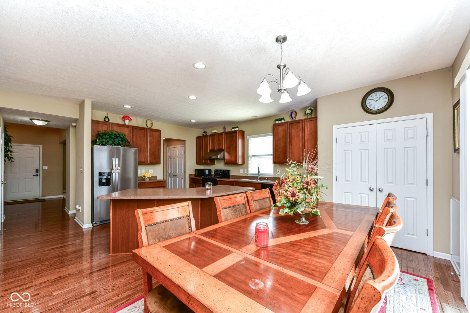Open-concept kitchen and dining with rich wood finishes.