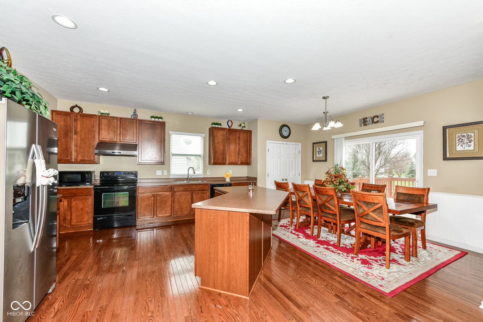 Spacious kitchen with cherry cabinets and large island.