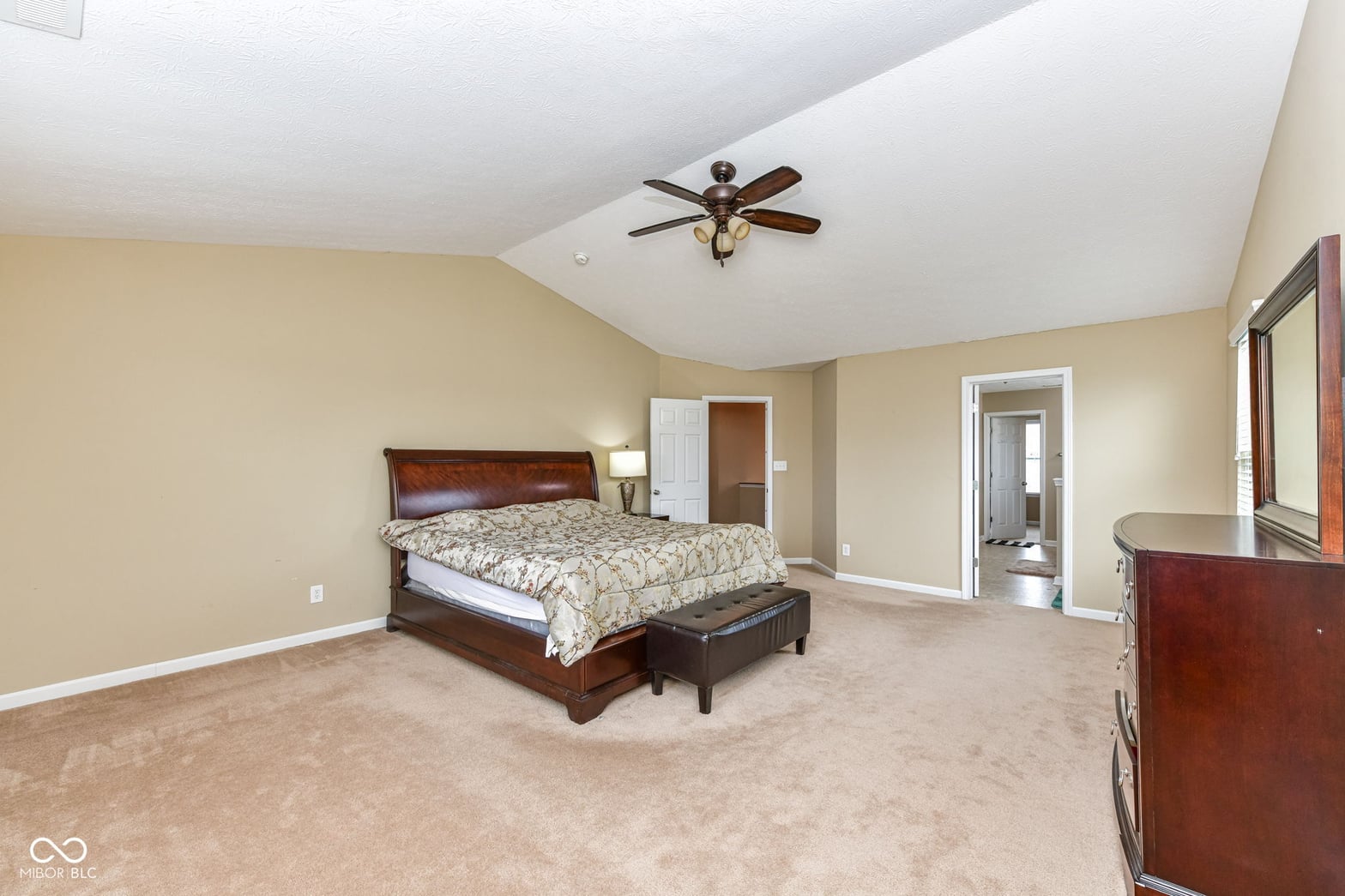 Spacious primary suite with vaulted ceilings and ensuite.