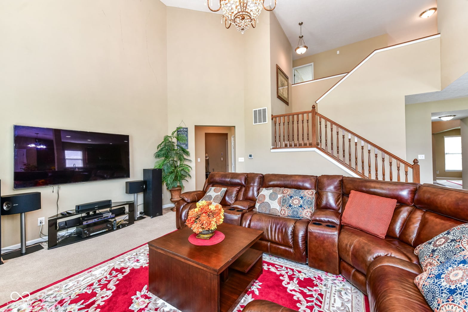 Spacious two-story family room with elegant furnishings.