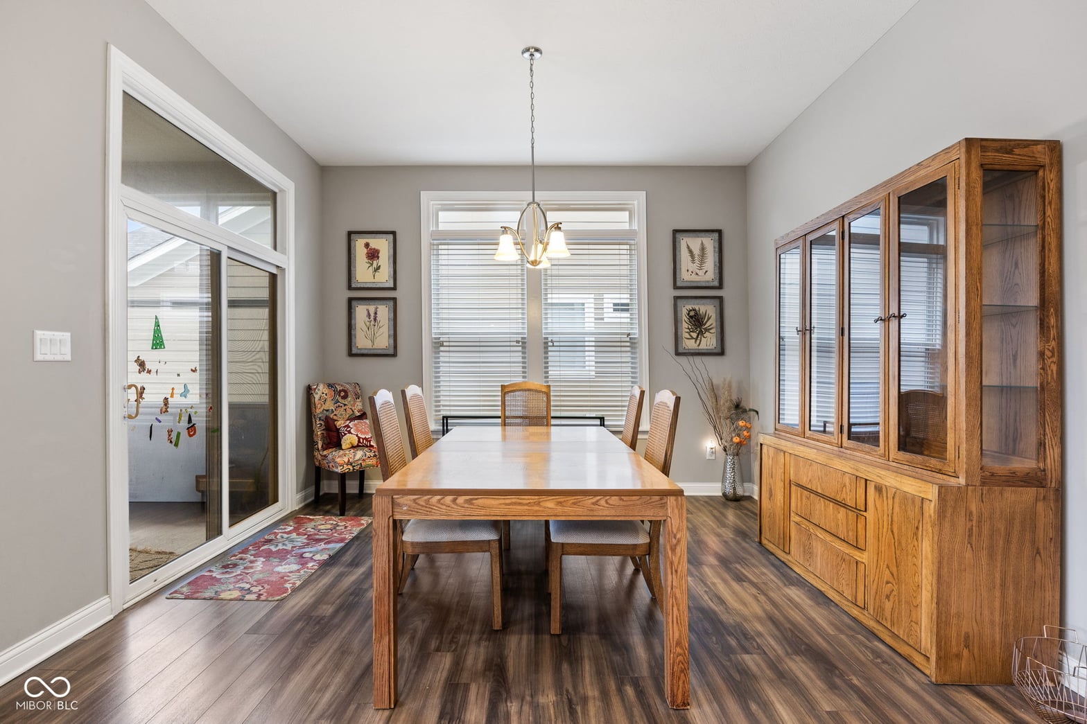 Bright dining room with hardwood floors and built-in storage.