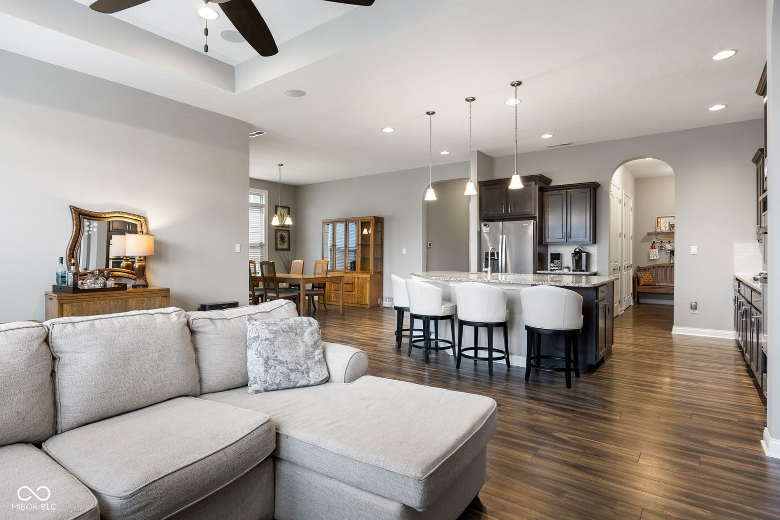 Spacious open concept with modern kitchen and hardwood floors.