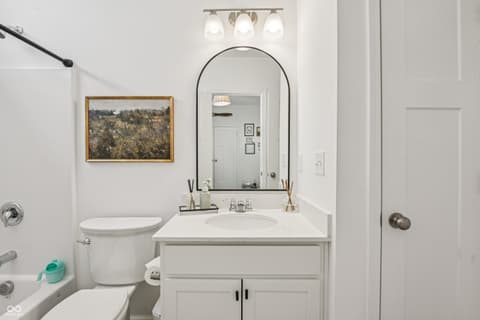 Primary bathroom at 82 Hovden Drive, Cicero, IN — Bright, updated primary bath with arched mirror and vanity.
