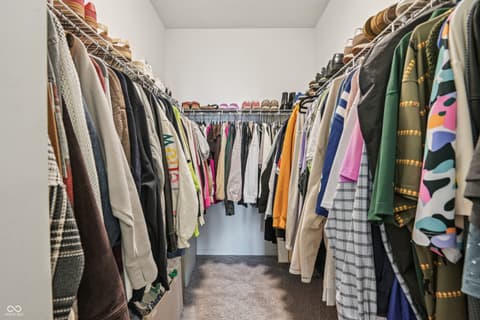 Bonus room at 82 Hovden Drive, Cicero, IN — Spacious walk-in closet with extensive dual hanging racks.