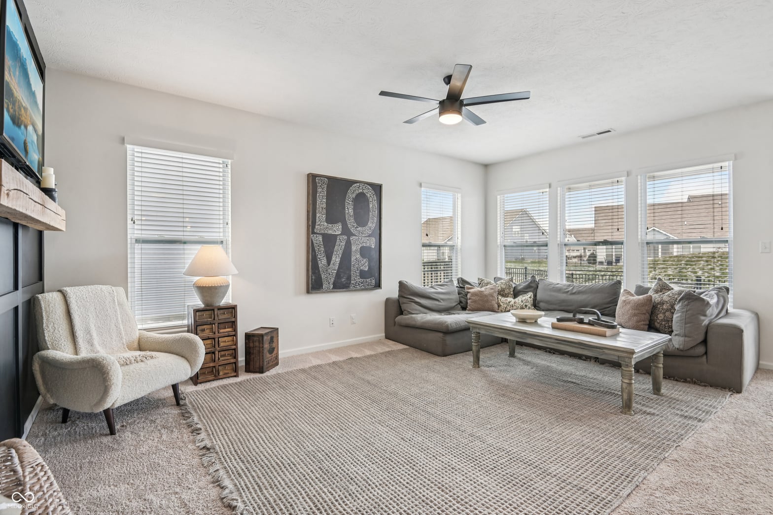Living room at 82 Hovden Drive, Cicero, IN — Bright open living room with expansive windows and views.
