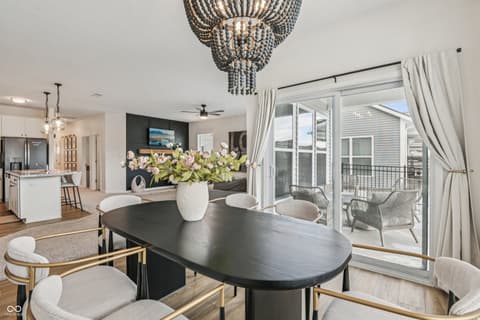 Dining room at 82 Hovden Drive, Cicero, IN — Modern dining with direct deck access and designer lighting.