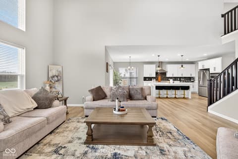 Living room at 12338 French Cattle Way, Noblesville, IN — Bright open-concept living with modern finishes throughout.