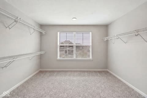 Bedroom at 12338 French Cattle Way, Noblesville, IN — Bright bedroom with spacious closet and organized storage.