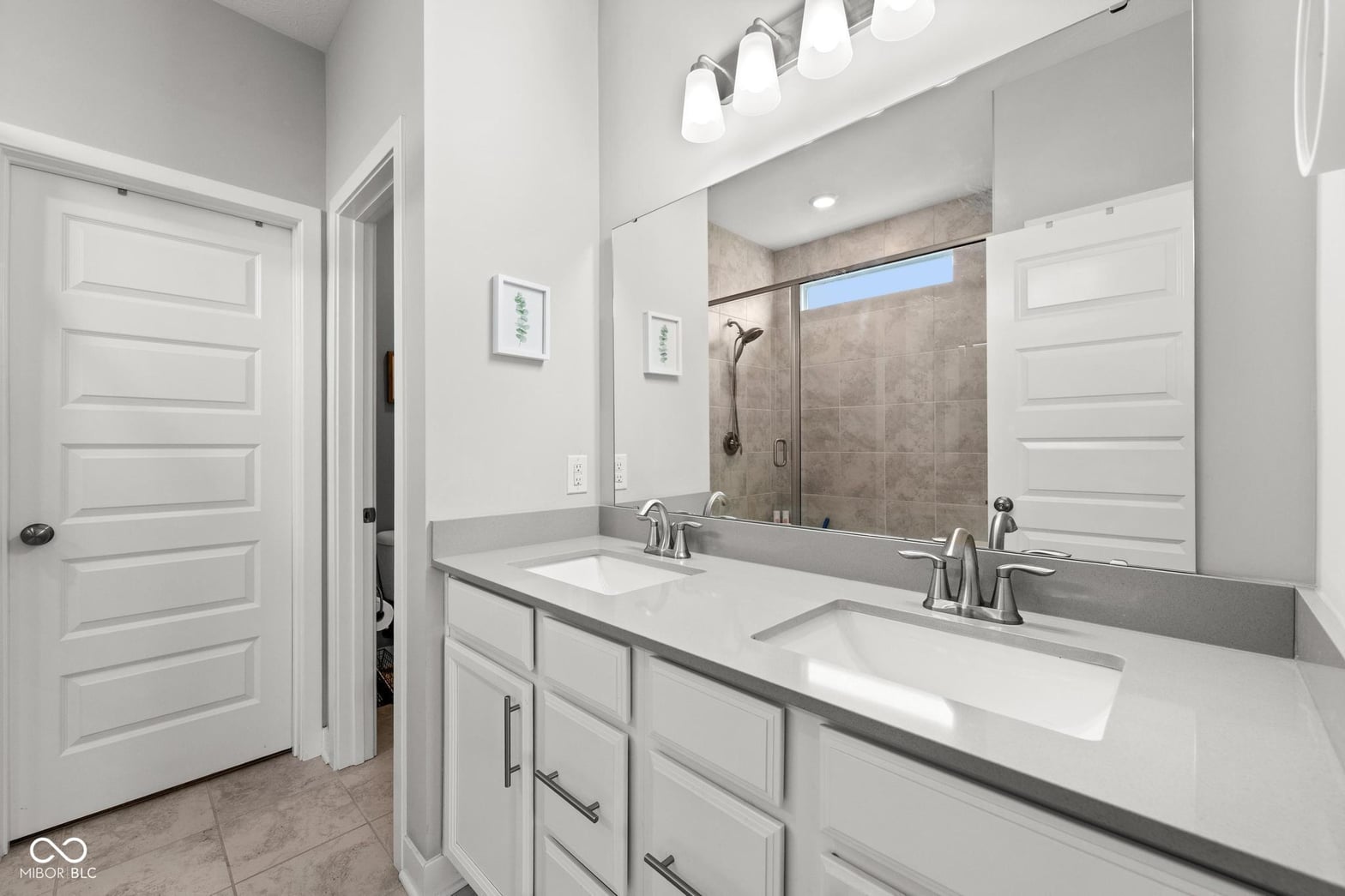 Spa-like primary bath with dual vanity and walk-in shower.