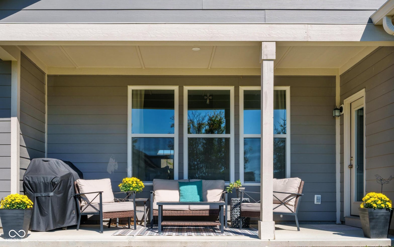 Spacious covered patio with modern seating and entertaining space.