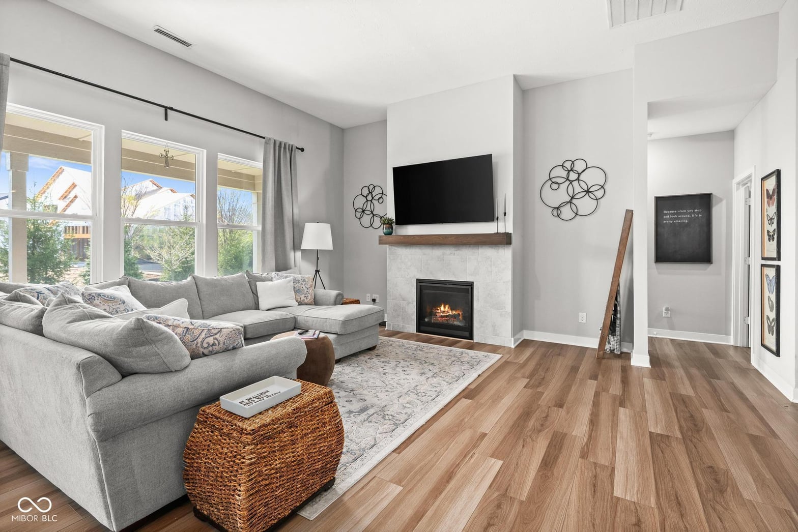 Bright living room with fireplace and abundant natural light.