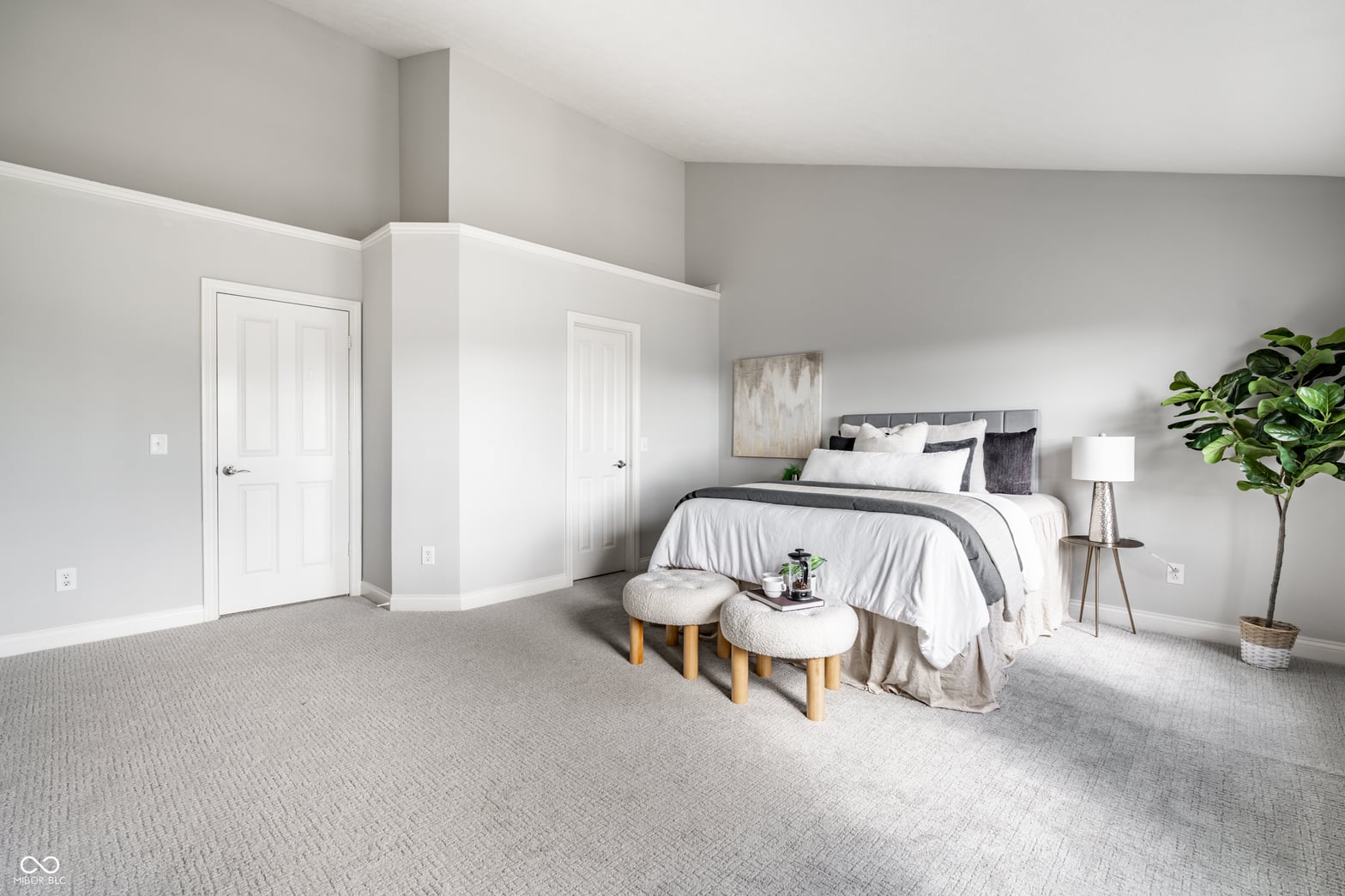 Bright, spacious primary suite with dual closets and vaulted ceilings.