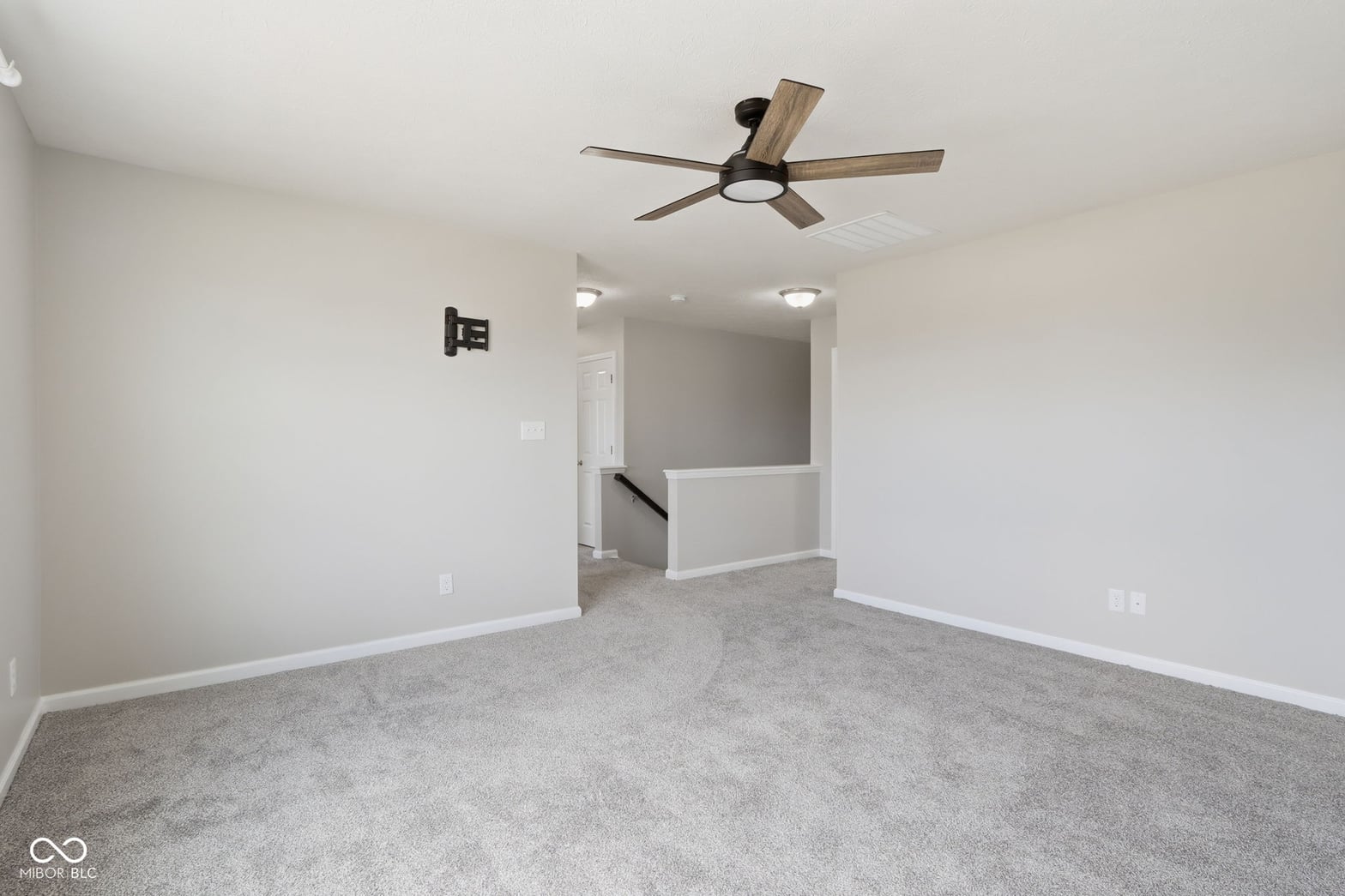Spacious open layout with modern ceiling fan and recessed lighting.